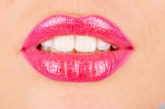 Close up of a young woman's glossy lips