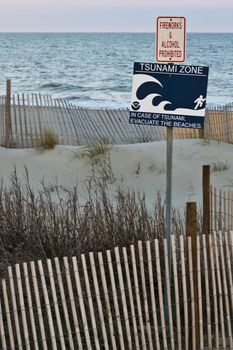 tsunami zone warning sign on the beach 