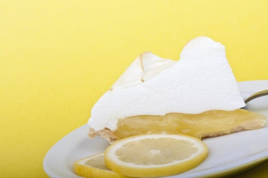 lemon meringue pie slices of lemon on a yellow background