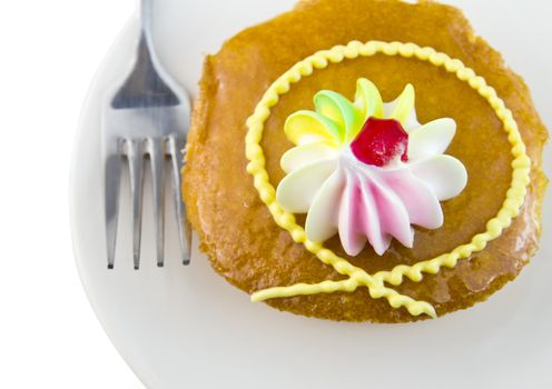 Cup cake and fork on white background