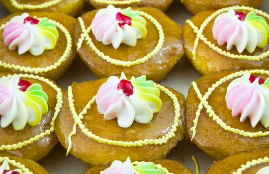 Freshly baked cup cakes with colorful flowers