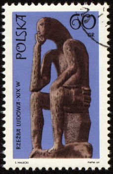 POLAND - CIRCA 1969: a stamp printed in Poland, shows statue of seated man, series "Folk sculpture", circa 1969