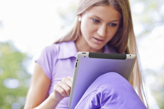 Beautiful Young Woman With Tablet Computer In Park