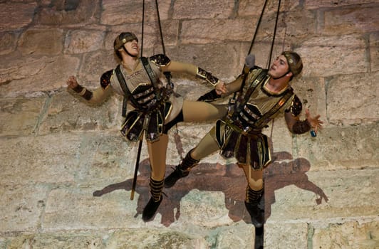 JERUSALEM - NOV 03 : An Israeli acrobats dressed as knight climbing on the old city walls in the annual medieval style knight festival held in the old city of Jerusalem on November 03 2011