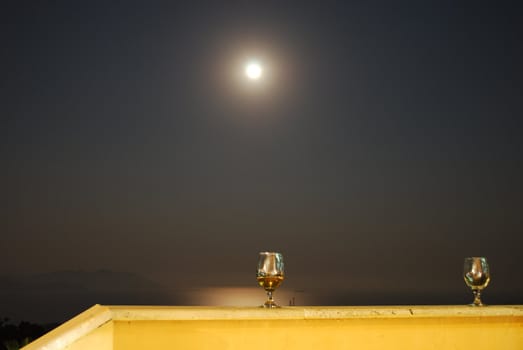 Romantic Scene of Wineglass and Full Moon with Sea at Background