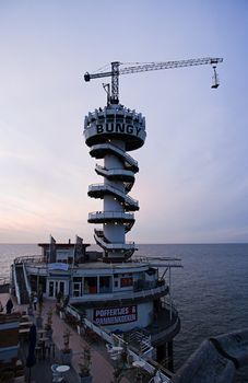 SCHEVENINGEN -THE NETHERLANDS-JULY 2007-Bungyjumping on the pier at sunset