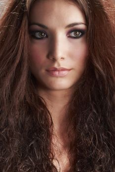 Portrait of beautiful young woman with make-up on grey background