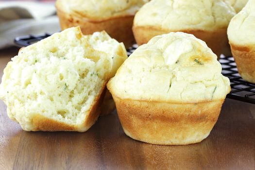 Savory muffins made with chives and feta cheese. Shallow depth of field with blur on lower portion of image. 