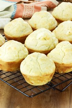 Savory muffins made with chives and feta cheese. Shallow depth of field with selective focus on center muffin and some blur in lower portion of image. 