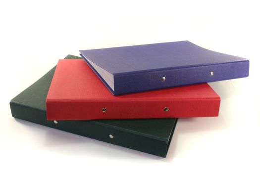 colored file folders in a pile on a white background