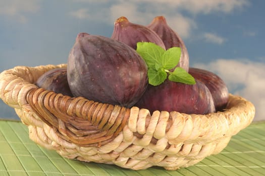 whole figs with peppermint on a basket