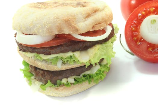 double hamburger with fresh vegetables on white background