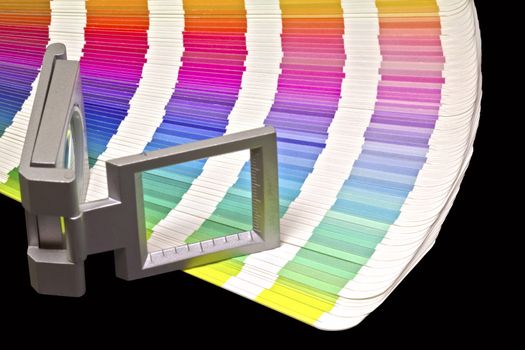 Color guide for offset print with a magnifier lens over the table