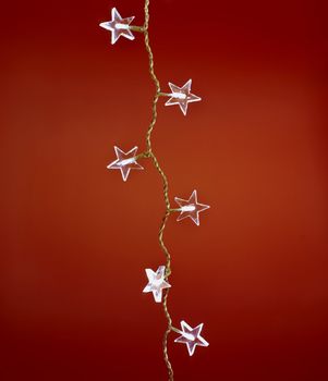 christmas star light isolated on red background