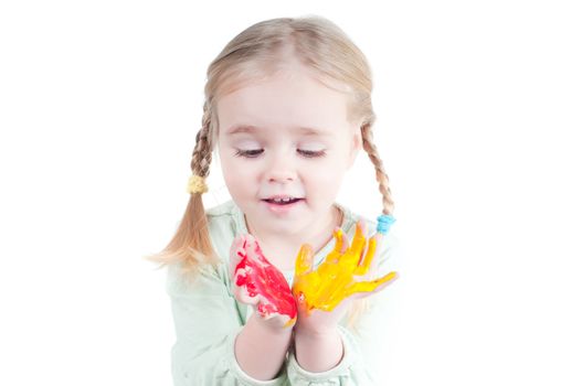 Studio shot of little girl playing with colors