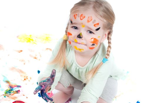 Studio shot of little girl playing with colors