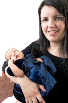 A newborn infant being held in the arms of her smiling mother isolated over a white background.