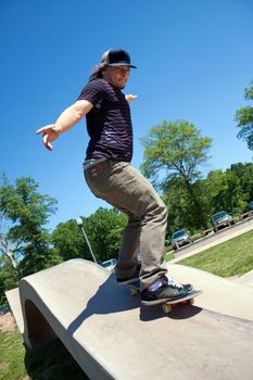 Action shot of a skateboarder performing a rail grind at a skate park.