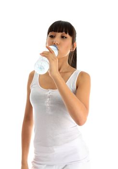 Pretty young woman drinking water from a plastic bottle