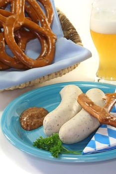 veal sausage with sweet mustard and pretzels on a white background