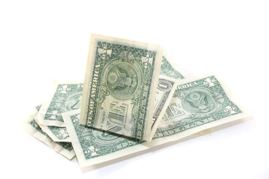 a pile of dollar bills in front of white background