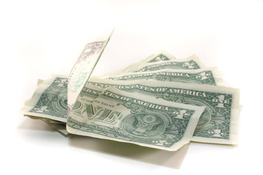 a pile of dollar bills in front of white background