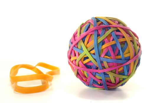 Rubber ball of different colored rubber against white background