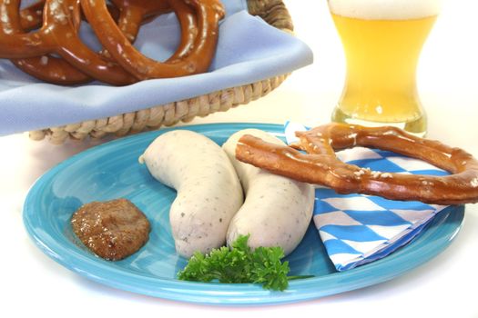 veal sausage with sweet mustard and pretzels on a white background