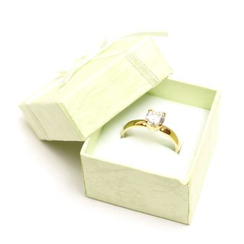 A beautiful diamond ring in a light green jewelry box.