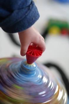 Child hand on spinner in motion