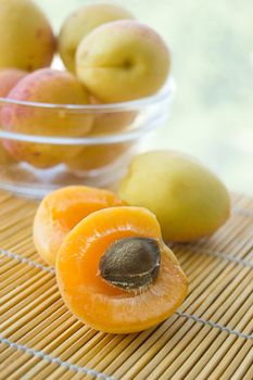 Fresh apricots in plate on green back