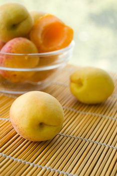 Fresh ripe apricots in plate on table