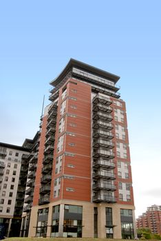 Luxury Red and Black Apartment blocks in a Yorkshire City under a blue sky