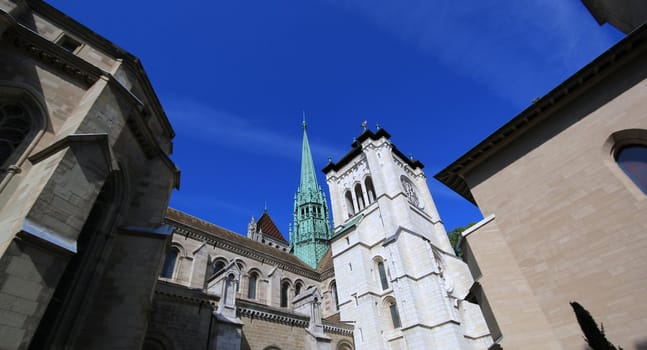 Side of protestant Saint-Peter's cathedral in Geneva, Switzerland, by beautiful weather. The construction started in 1160 and lasted about one century. After that, it's been modified several times, sometimes because of fire. At XVI century, when the protestant Reformation advented, the inside was modified to have less decoration.