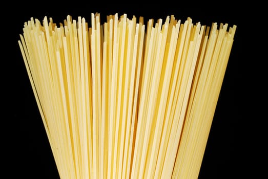 Uncooked spaghetti close up isolated on black