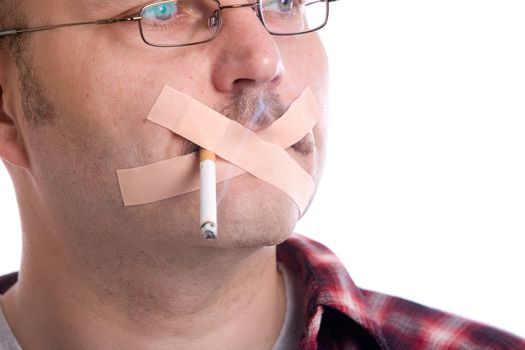 Mature man with a cigarette in his mouth and bandaids across