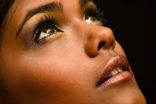 Studio portrait of an Indian  Indonesian beauty model looking up