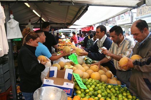 People at a vegetables market stall