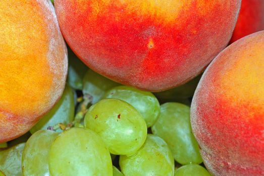 appetizing bunch of green grapes and same peach, green and red color