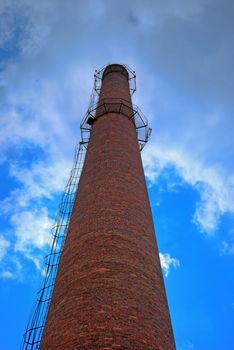 urban chimney-stalk on a background cloudy sky