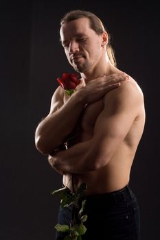 standing romantic man with red rose
