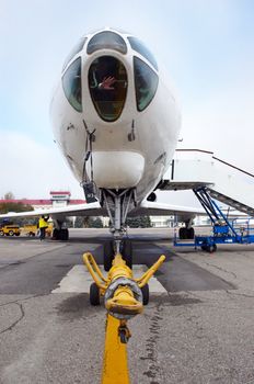 airplane at the airfield ready to be moved by tractor