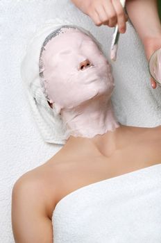 beauty salon series. applying of cleaning facial mask.
