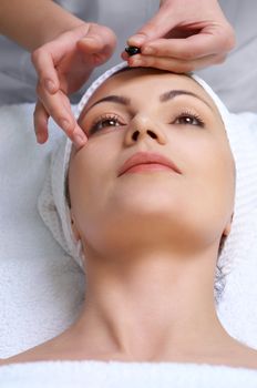 applying of vitamin capsule treatment for facial skin in the beauty salon