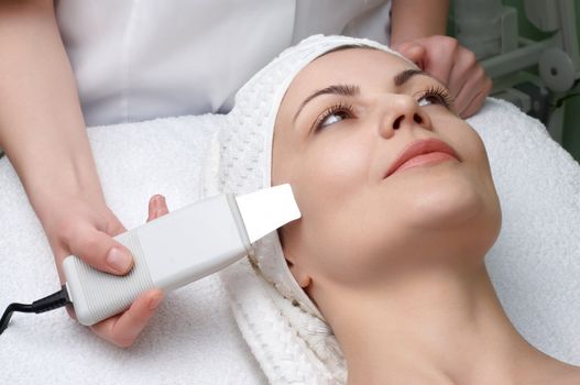 woman getting ultrasound skin cleaning at beauty salon