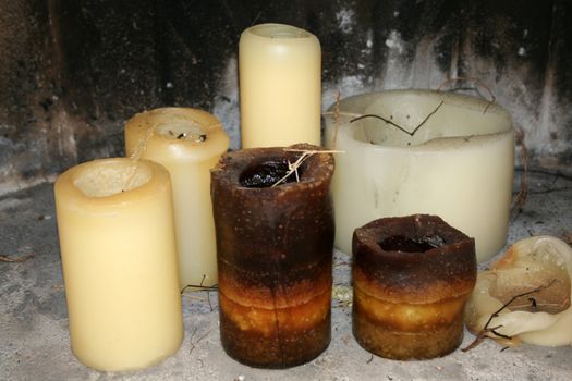 selection of candles in a fireplace