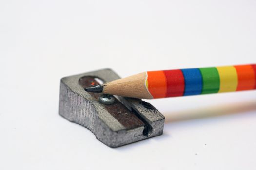   a coloured sharpened pencil on a sharpener