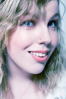 Studio portrait of a curly blond female