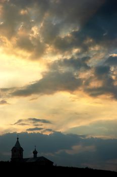 dark silhouette of church on the sunset background. Tsipova, Moldova.