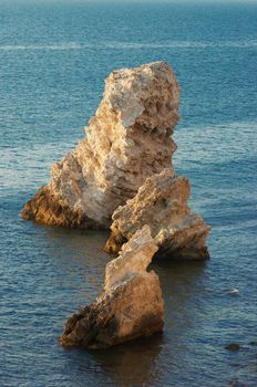 calm blue sea around the limestone rock